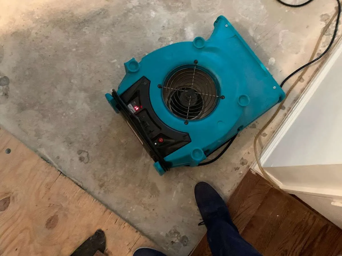 Air mover drying subfloor during Commercial Water Damage Restoration in Dublin